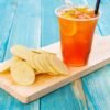 Orange Juice with Chips - Potato Chips with Orange Juice on Blue Wood Backgro